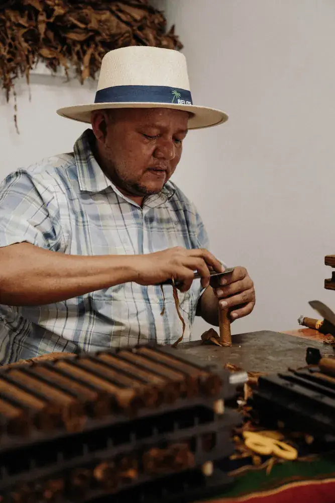 The roller shaping a cigar by hand